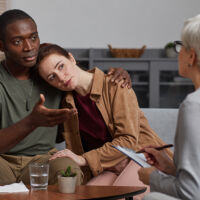Young multiethnic couple supporting each other while have consultation at psychologist