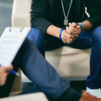 Close-up of anxious African American adolescent during psychotherapy session.